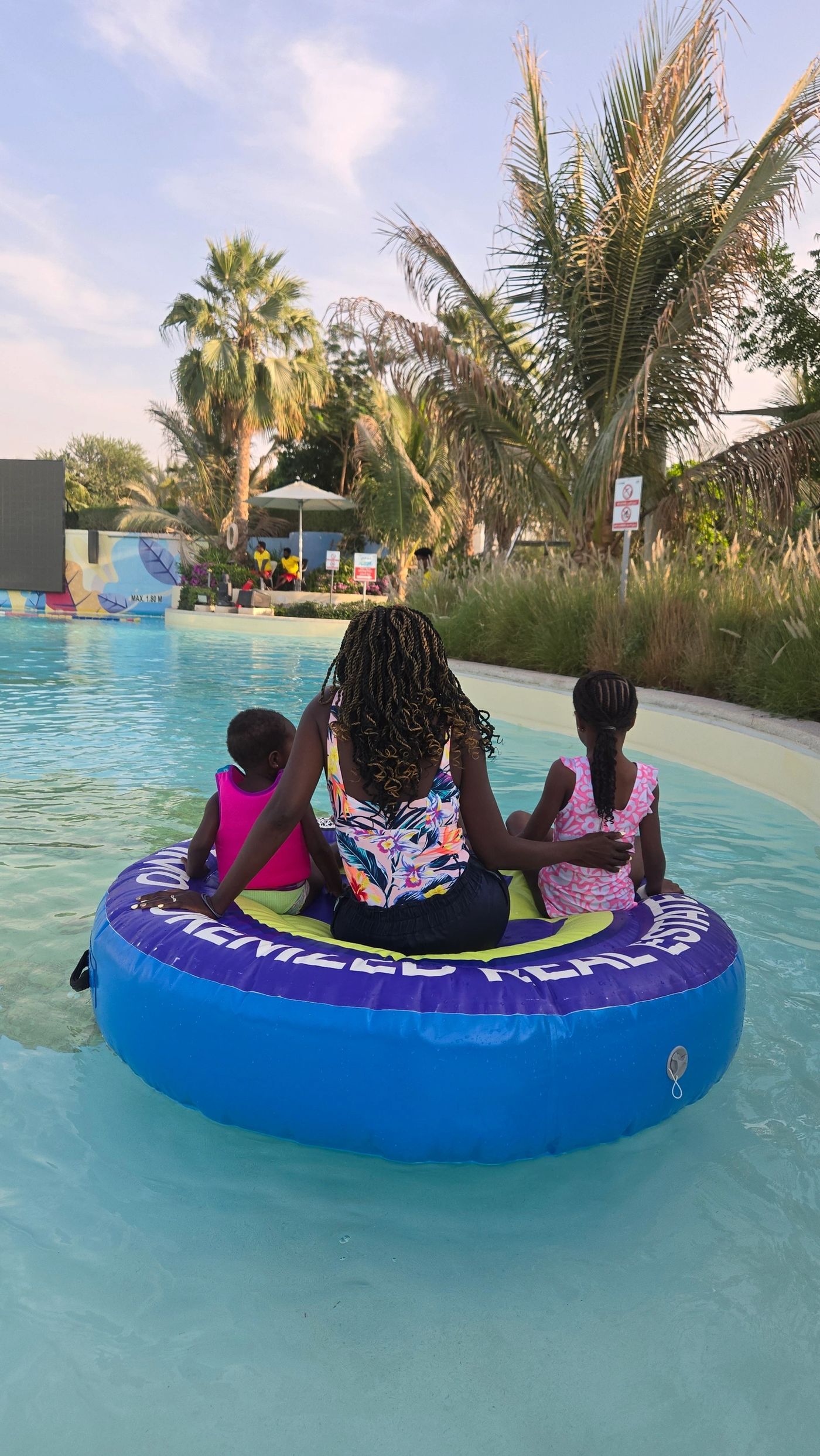Samira and her kids on a pool float