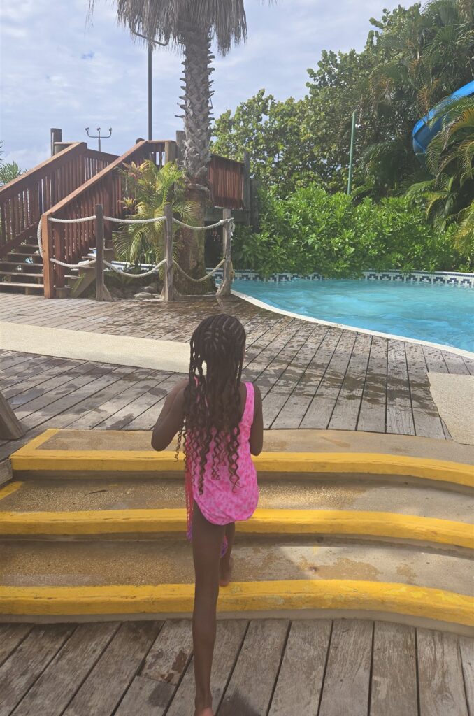 My daughter, seen from behind, heading to the pool and water slide in Negril, Jamaica