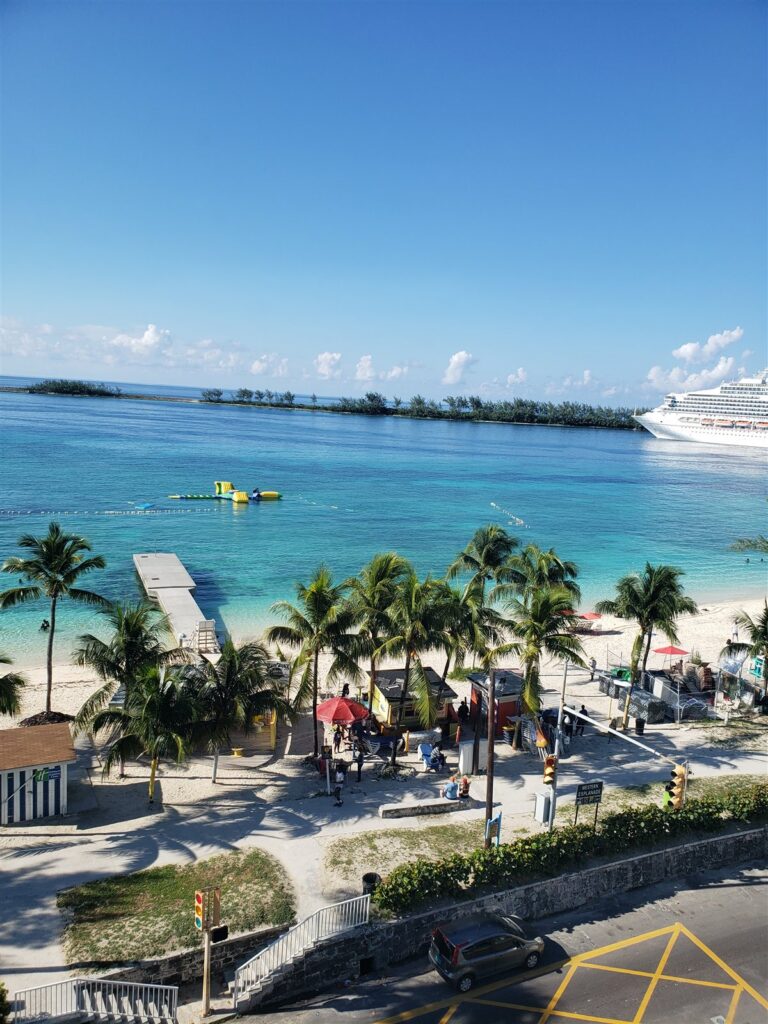 The beach and the turquoise water from our hotel in downtown Nassau, with a cruise ship in the harbour