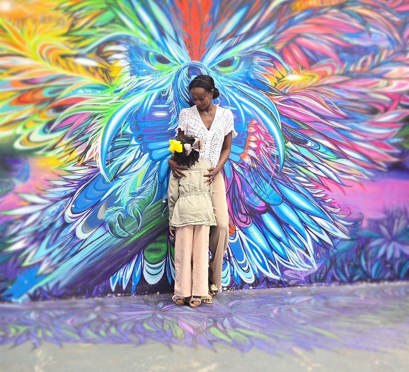 Samira Diallo of Mayana Voyage with her daughter at an owl mural in Sao Paulo, Brazil