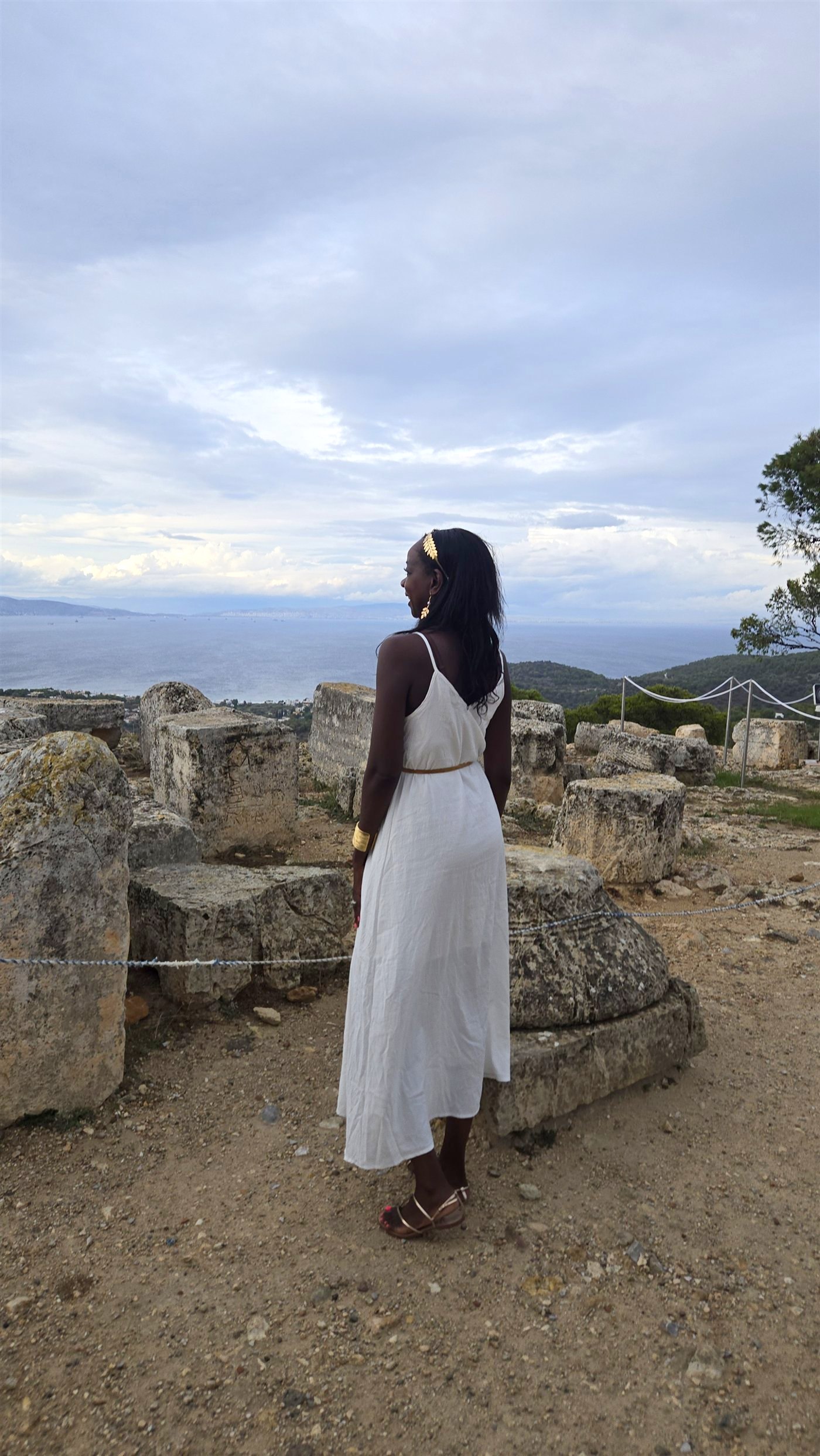 Samira looking at the sea from ancient ruins in Greece