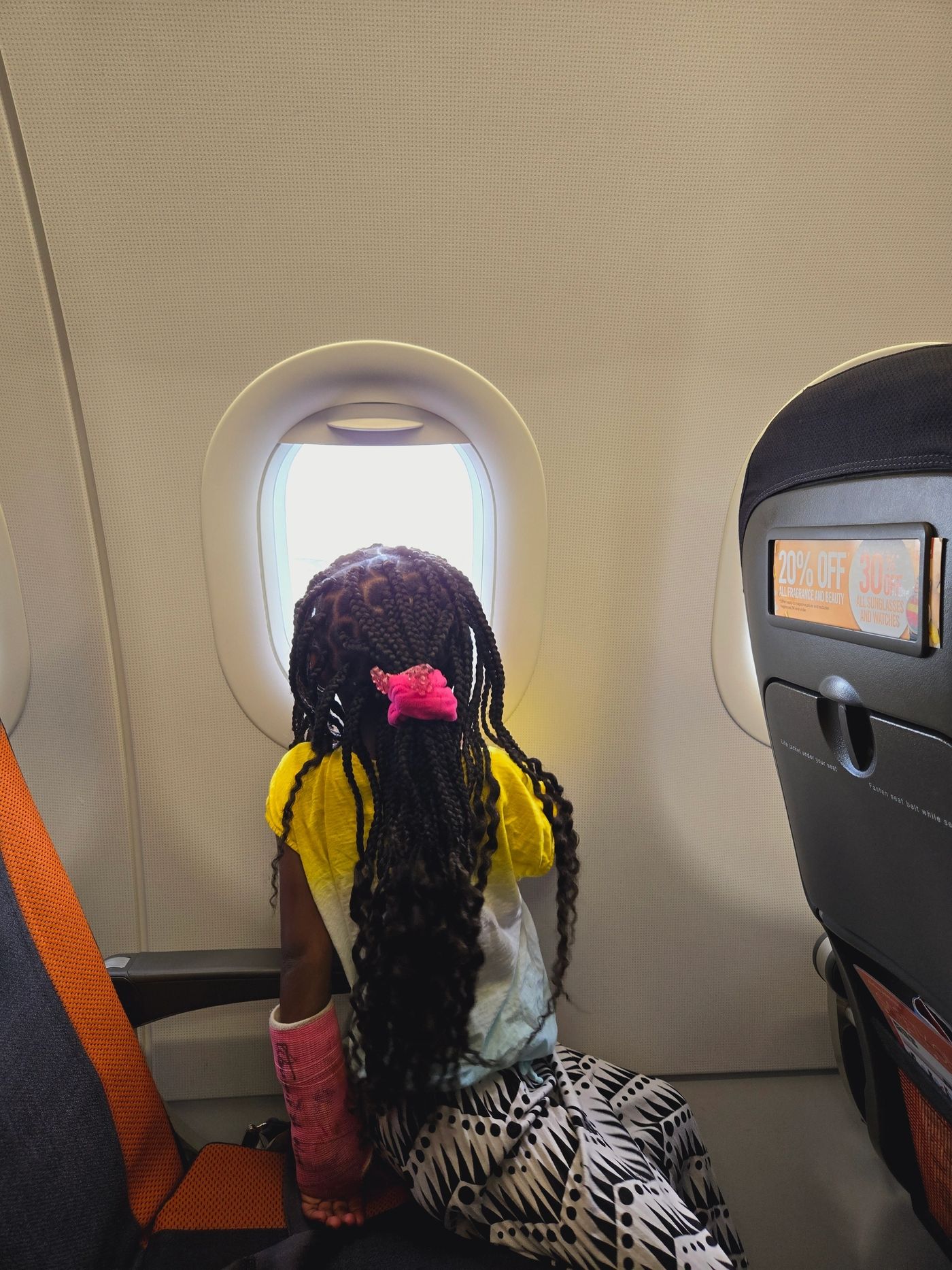 A child looking out of a plane window