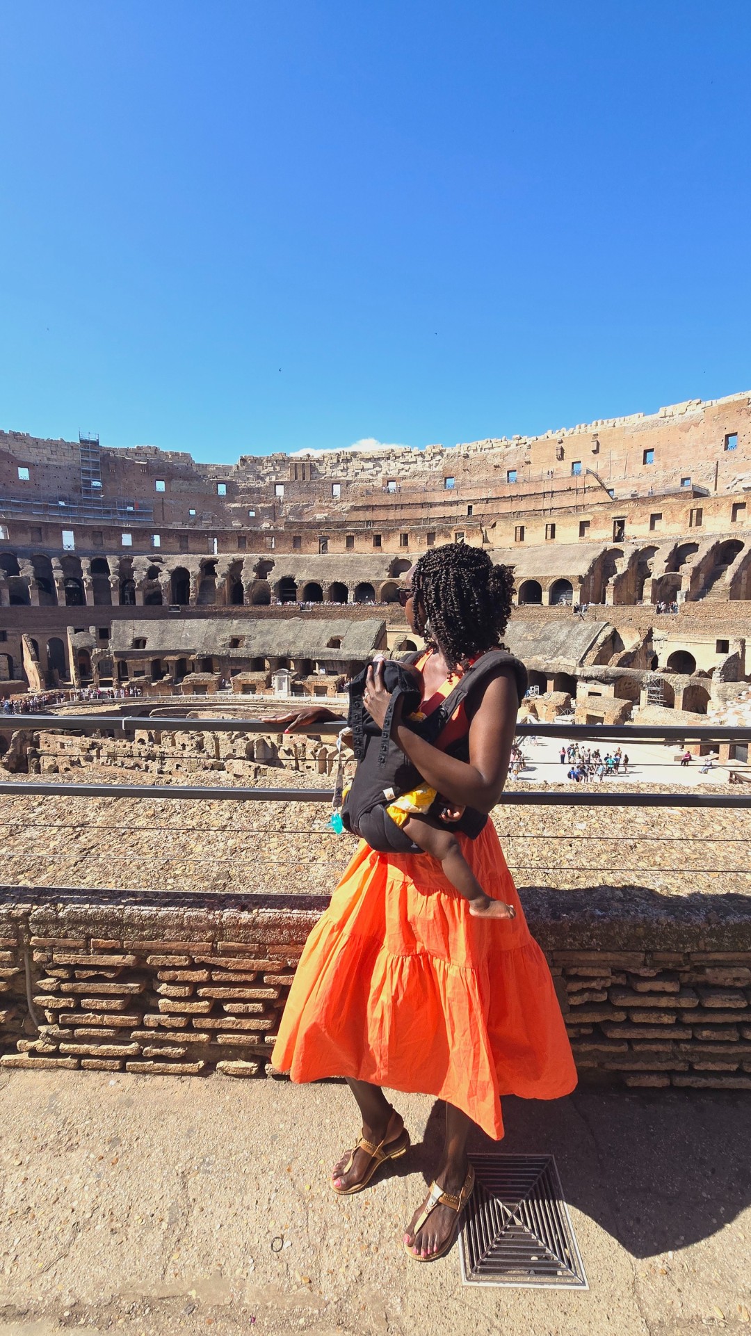 Samira and her kids at the Colosseum in Rome, seen from behind
